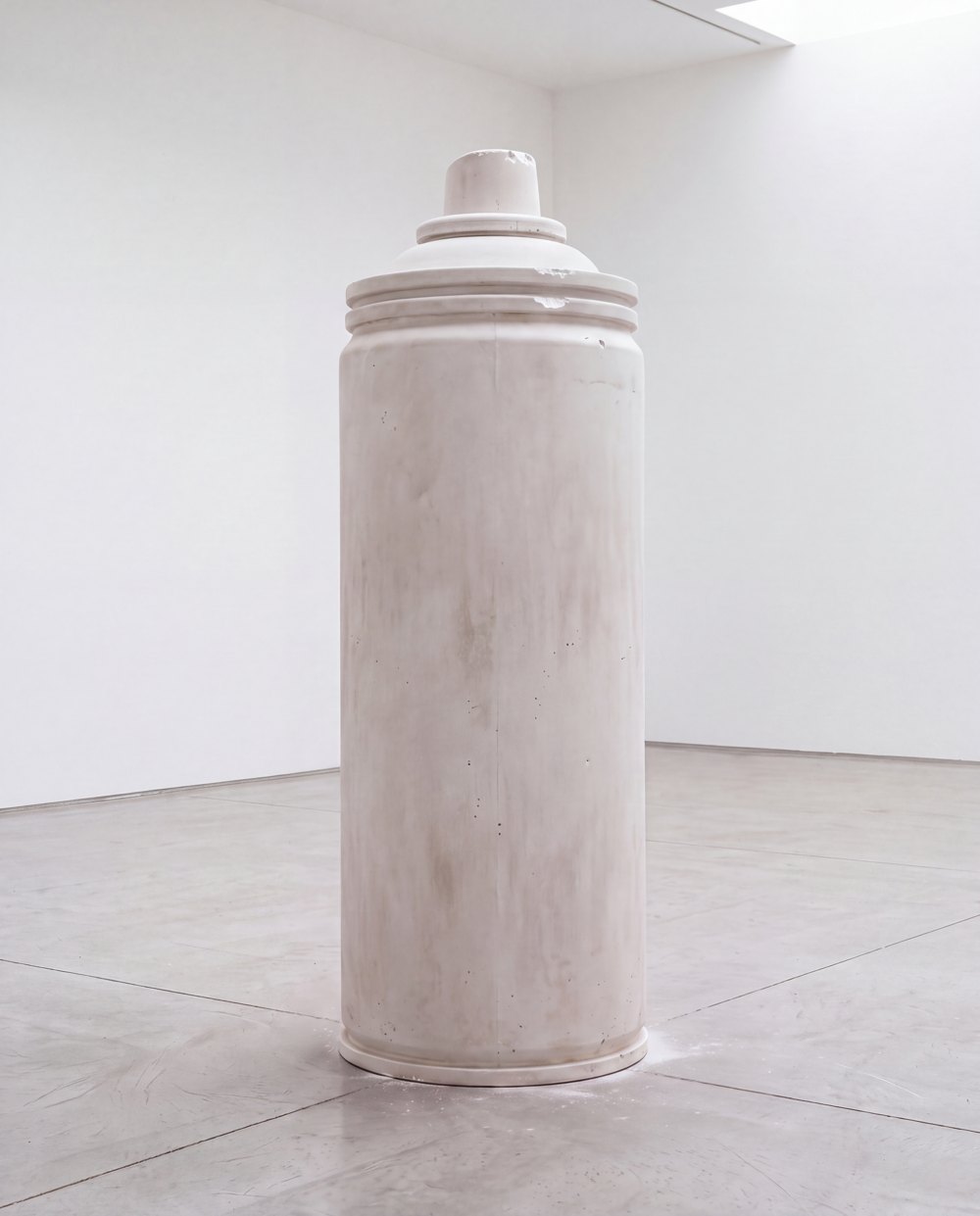 Concept mockup of an oversized plaster spray can in a white gallery